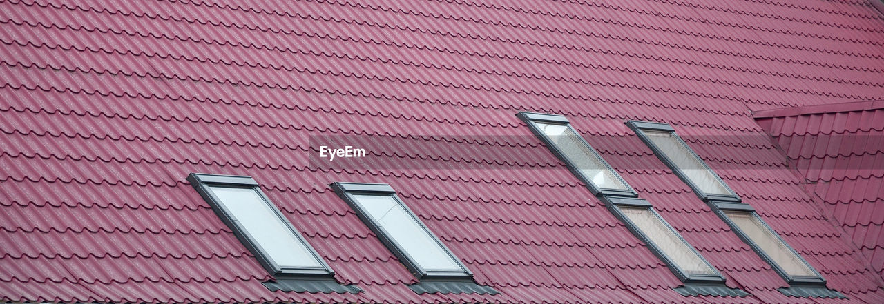 LOW ANGLE VIEW OF BUILDING WITH PINK UMBRELLA