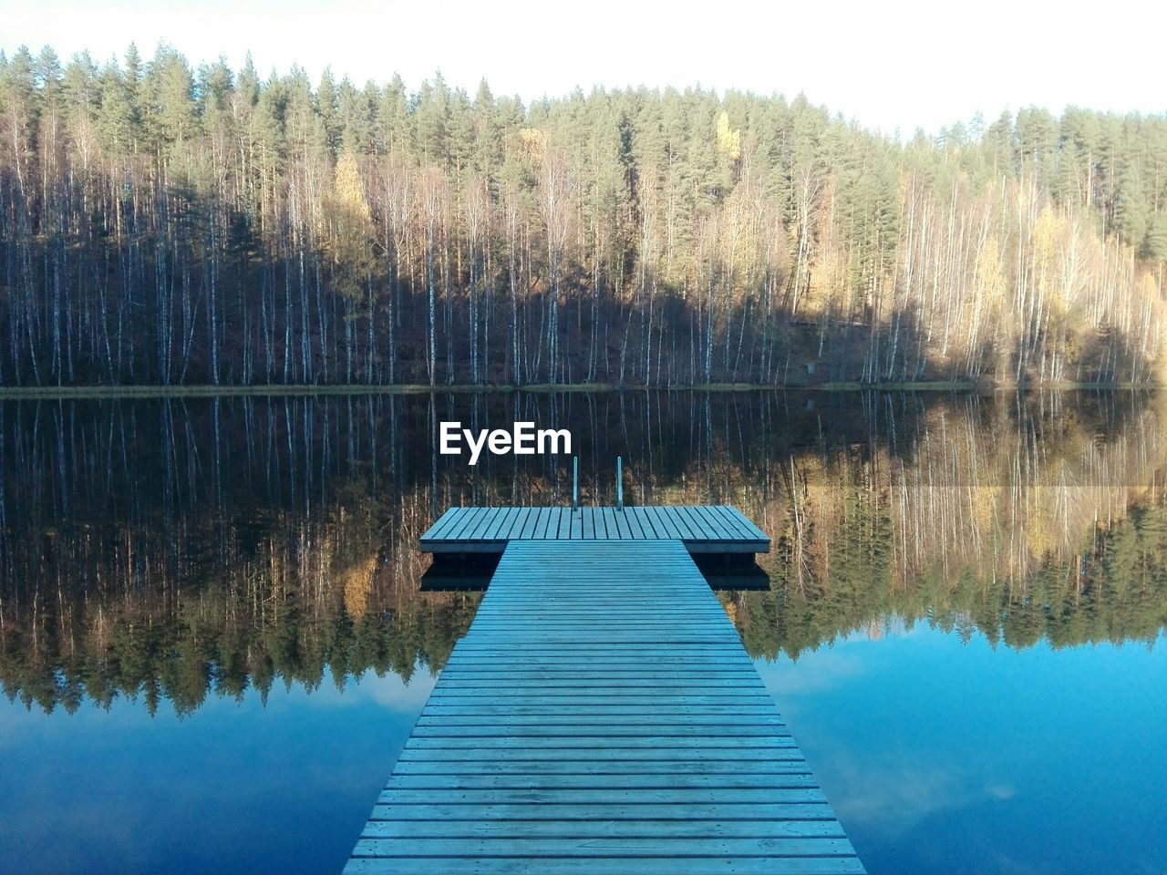 Pier on lake against sky