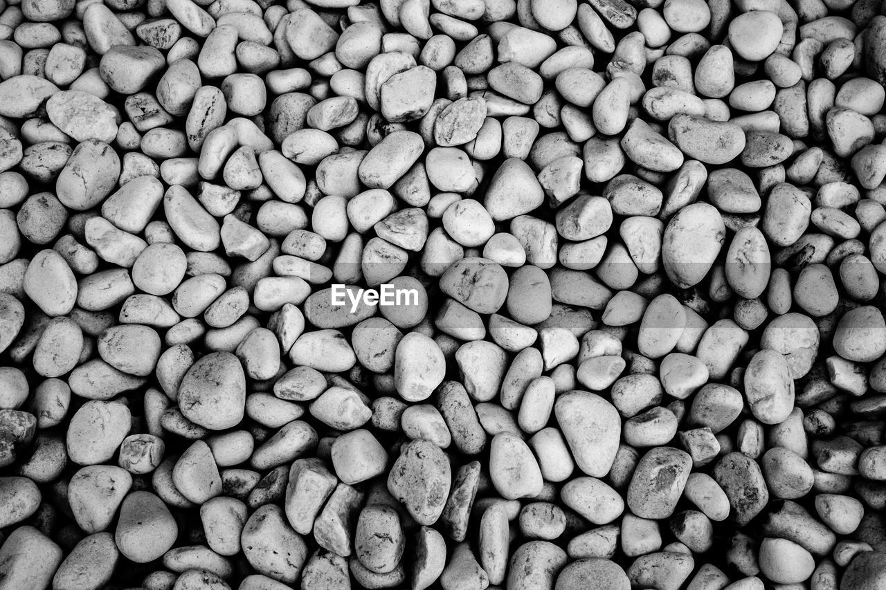 White and black round pebble stones as monochromatic background