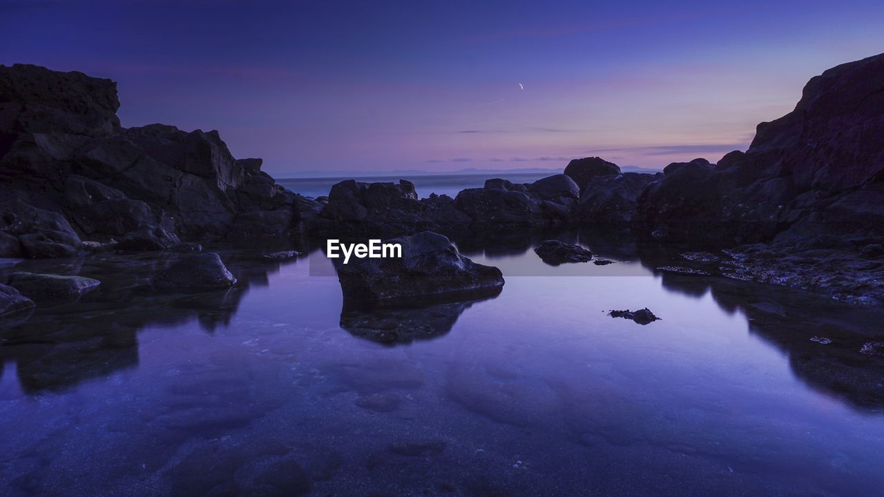 Scenic view of sea against sky at sunset