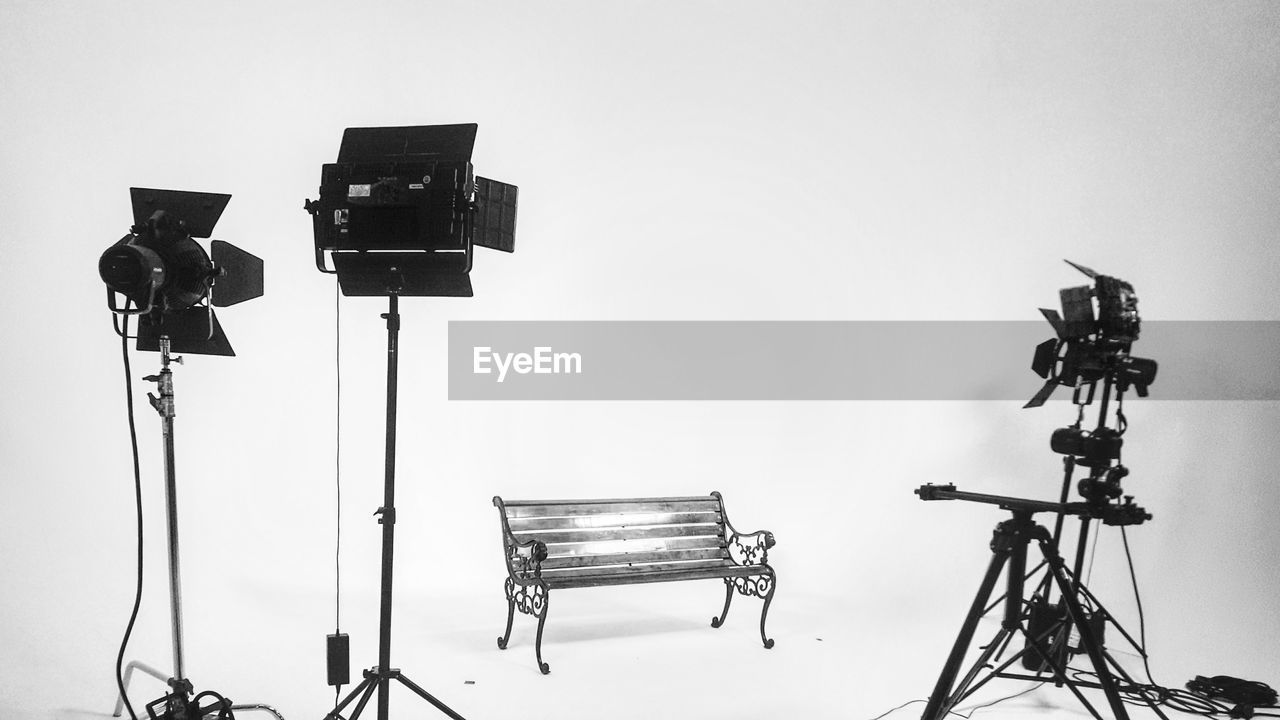 Bench with photographic equipment against white background