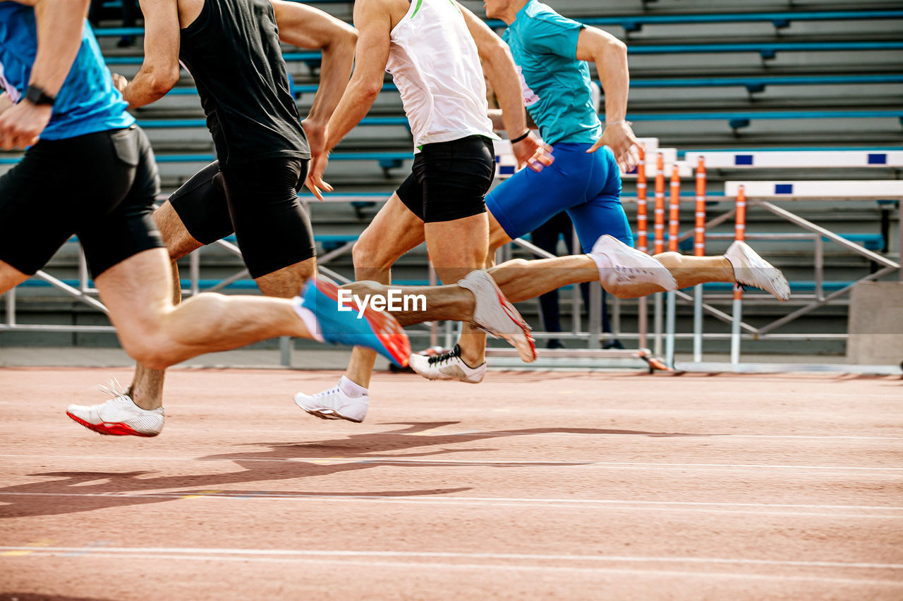 Low section of athlete running on track