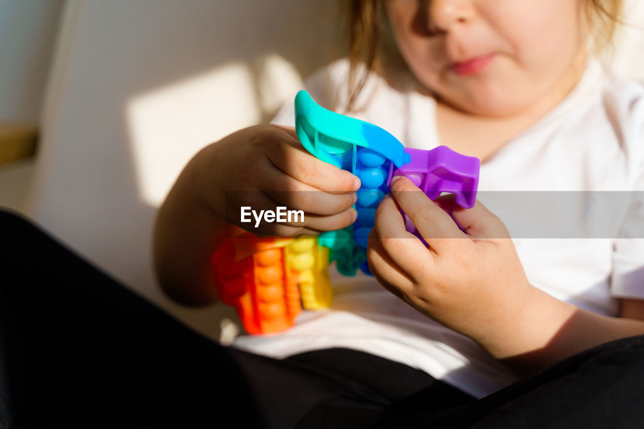 Midsection of girl playing with toy