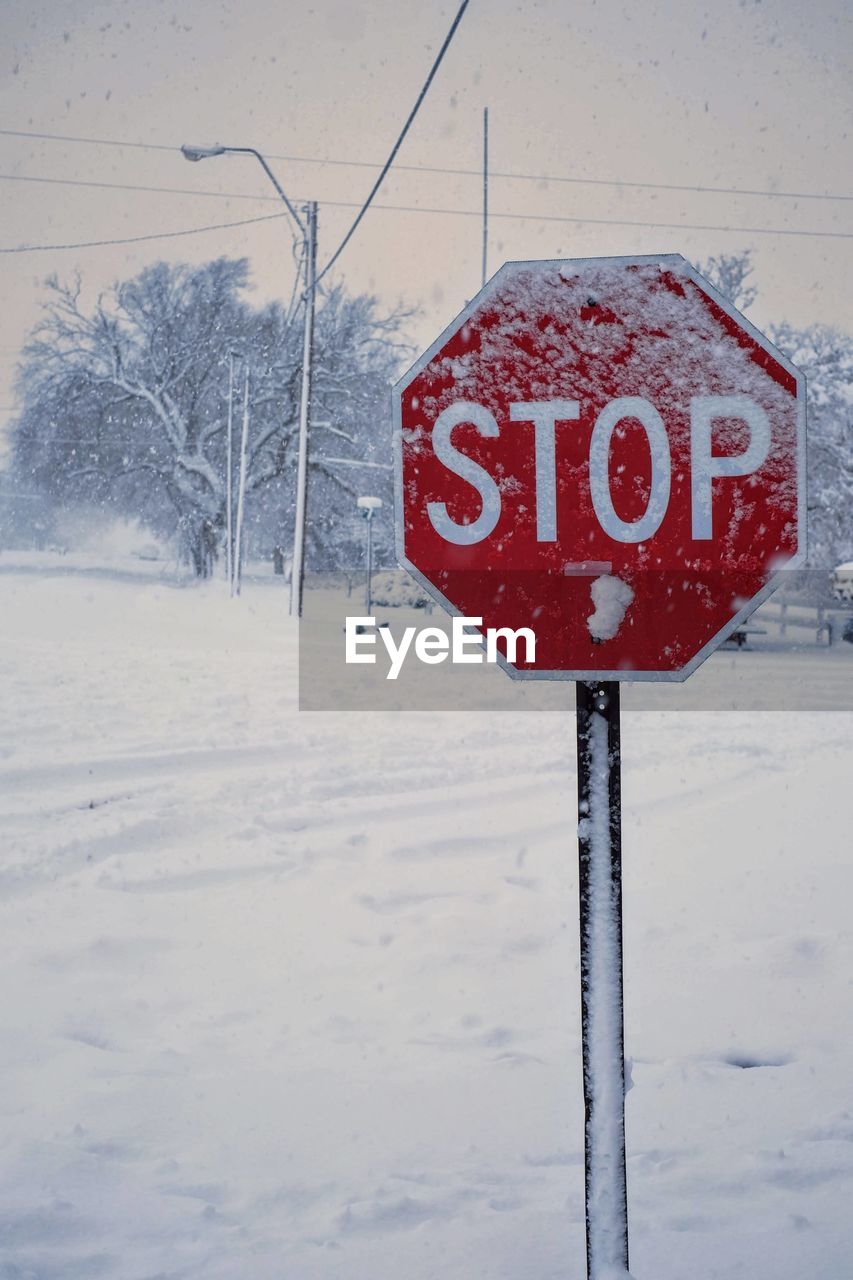 close-up of road sign on snow covered landscape