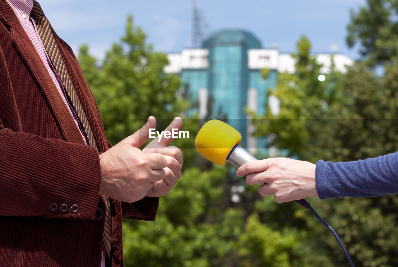 Journalist making media interview with businessman