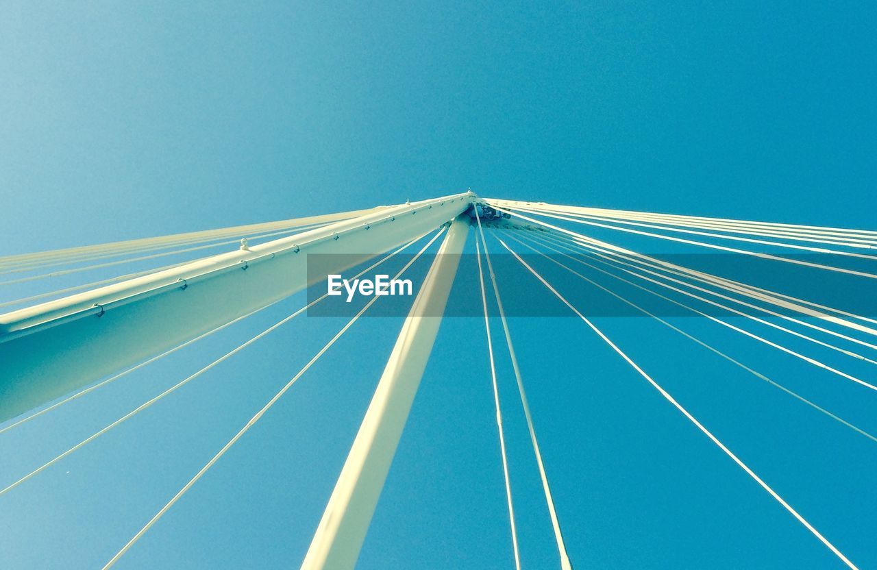 Low angle view of bridge against clear blue sky