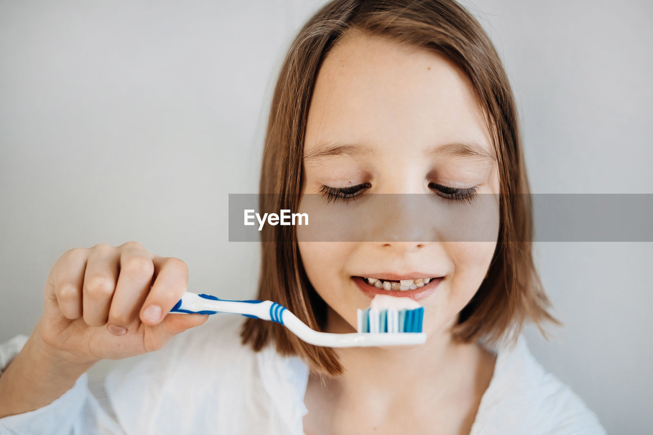 Girl brushes her teeth, dental care since childhood, a visit to the dentist