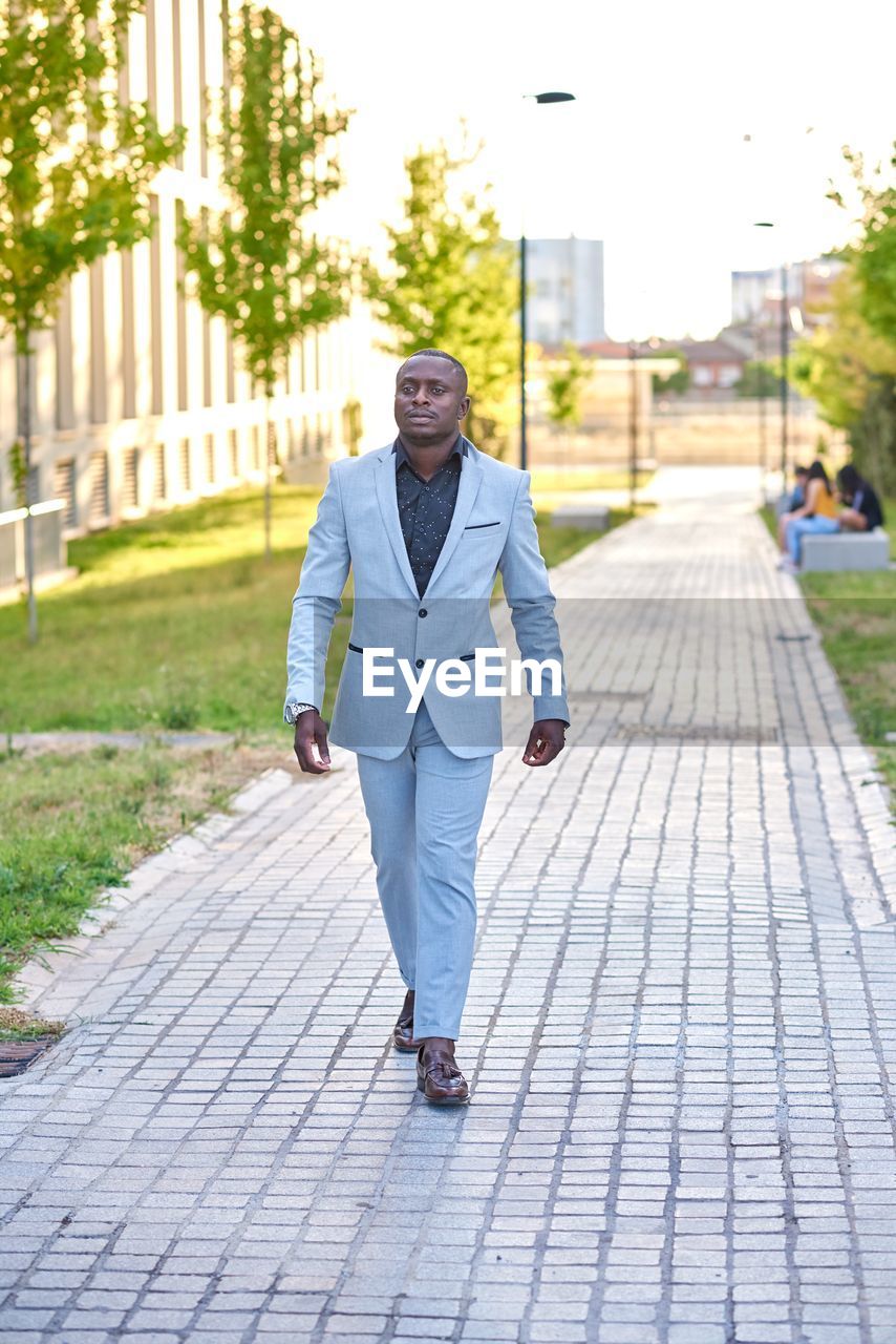 Stylish businessman walking down the street.