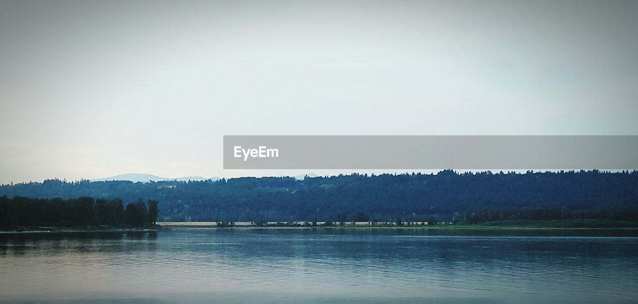 SCENIC VIEW OF LAKE WITH MOUNTAINS IN BACKGROUND