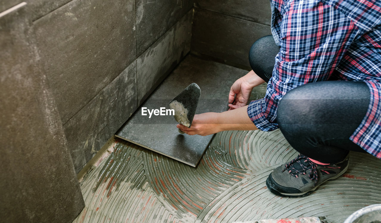 Low section of man sitting on floor