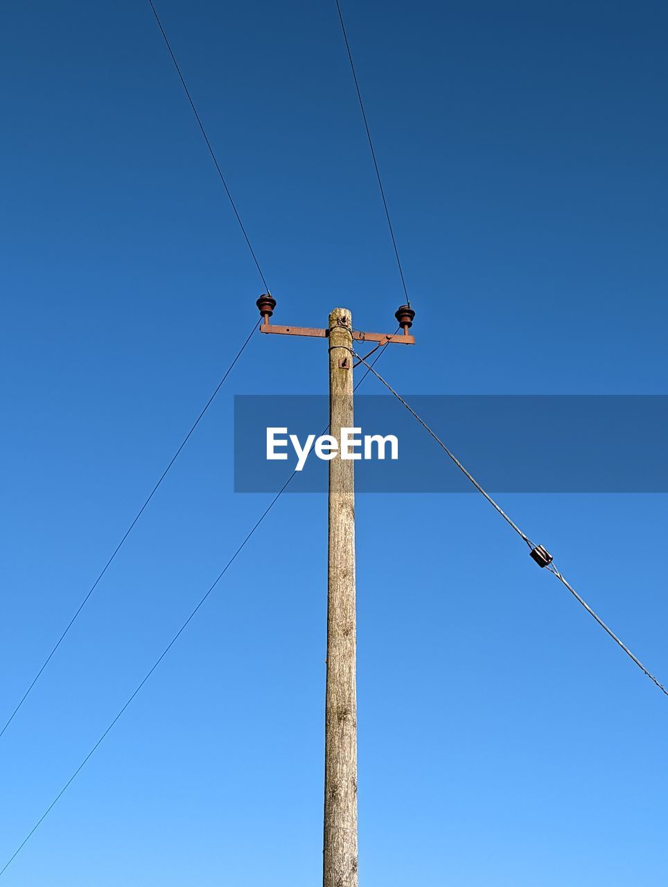 cable, electricity, blue, sky, technology, clear sky, overhead power line, low angle view, power generation, power supply, mast, nature, power line, line, street light, telephone line, day, no people, outdoors, electricity pylon, telephone pole, hanging, pole, equipment, communication, outdoor structure, sunny, copy space, architecture, electrical supply, industry