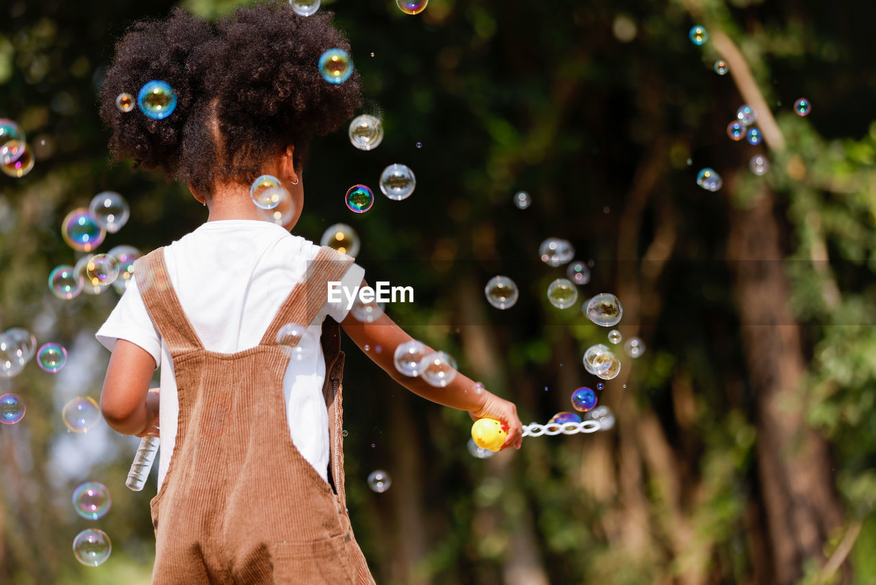 High angle view of woman standing at bubbles