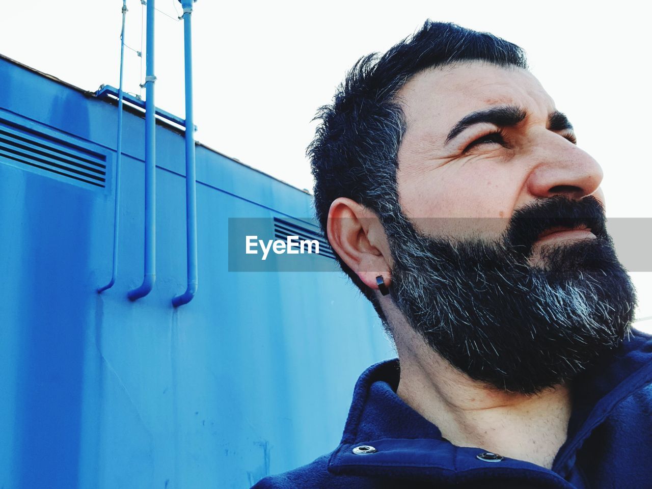 Close-up of man looking away standing outdoors