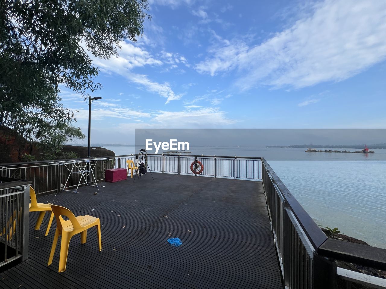 sky, water, nature, sea, cloud, architecture, no people, railing, tranquility, scenics - nature, day, outdoors, beauty in nature, tree, travel destinations, transportation, travel, chair, land, dock, seat, beach, tranquil scene, built structure, nautical vessel, wood, pier, trip, blue, vacation, holiday, plant, tourism
