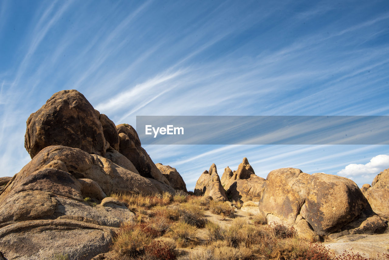 Rock formations on landscape against sky