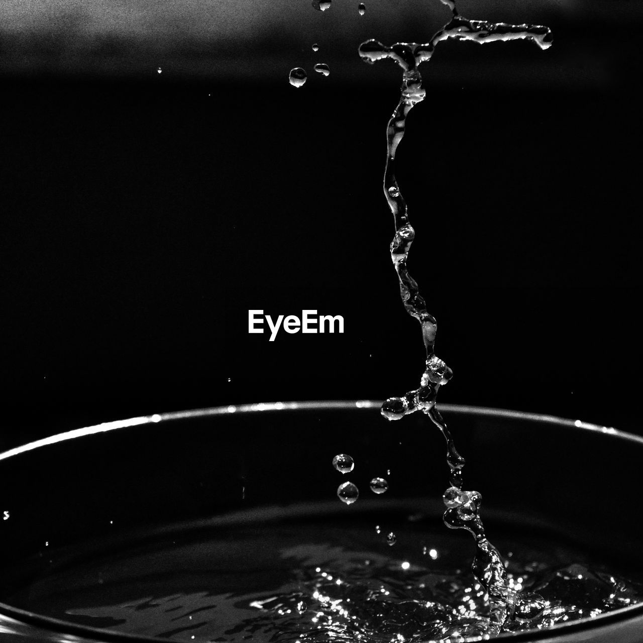 CLOSE-UP OF WATER SPLASHING AGAINST SKY