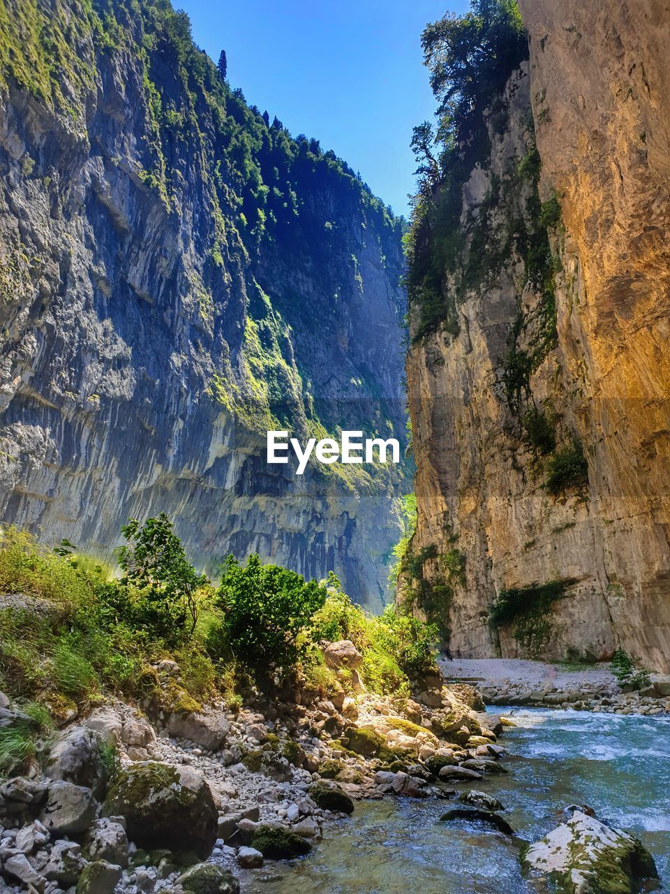 Scenic view of waterfall in mountains