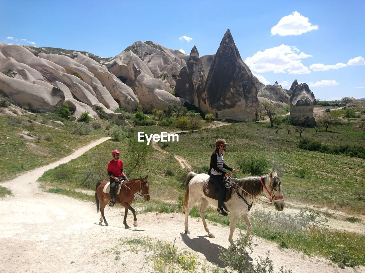 PEOPLE RIDING HORSES ON MOUNTAIN