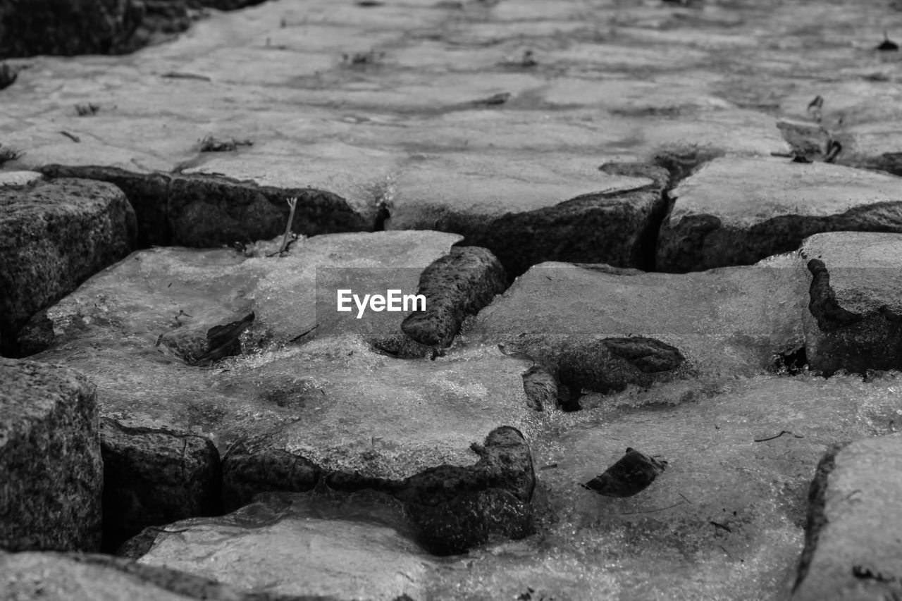 CLOSE-UP OF STONES AT BEACH