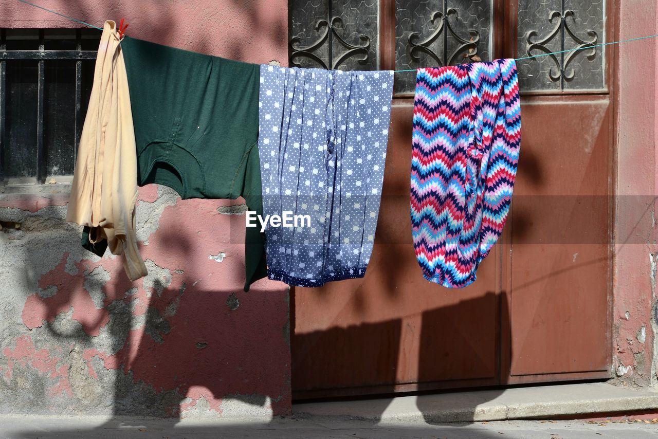 Clothes drying against wall