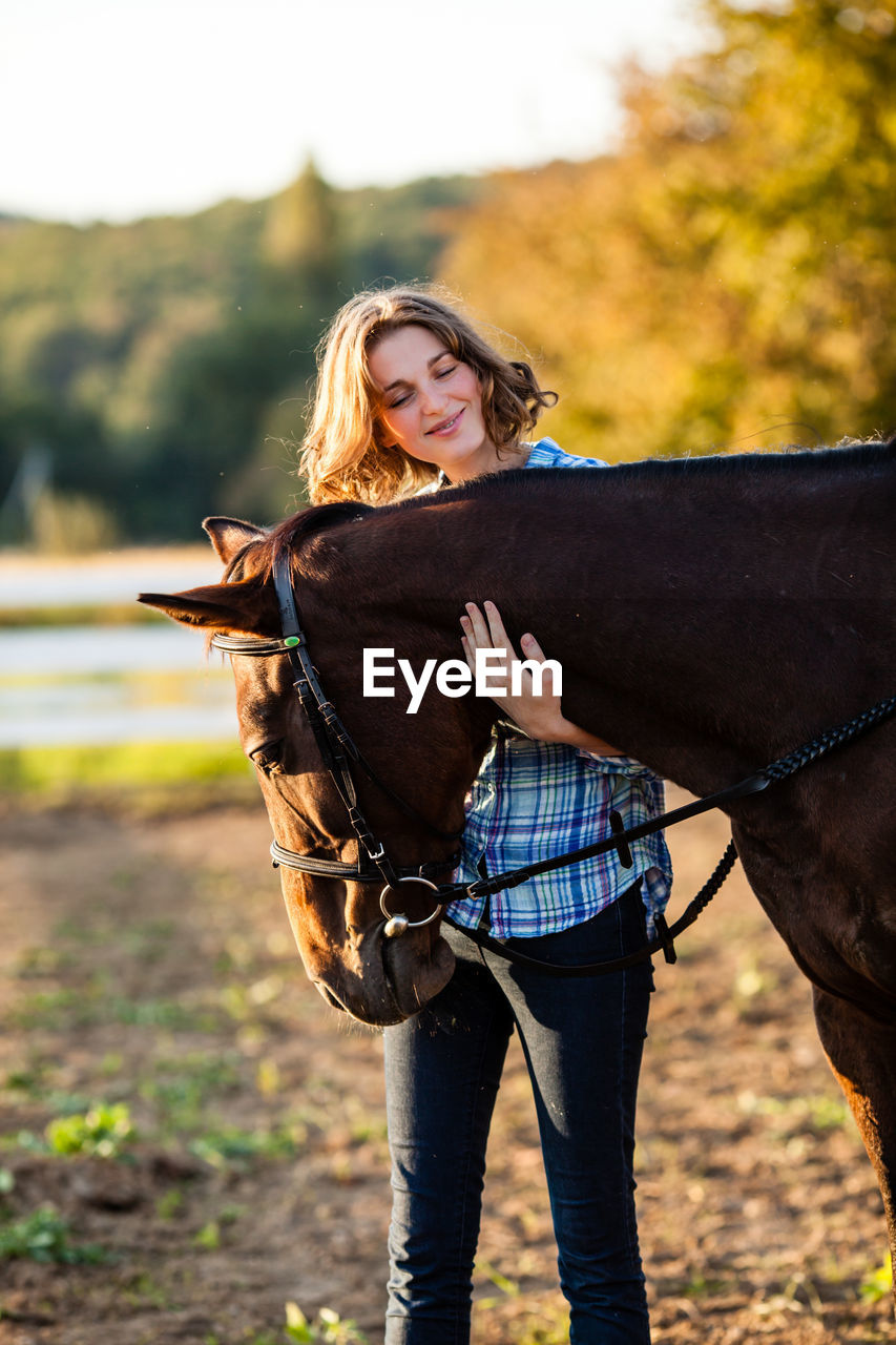 Close-up of woman embracing horse