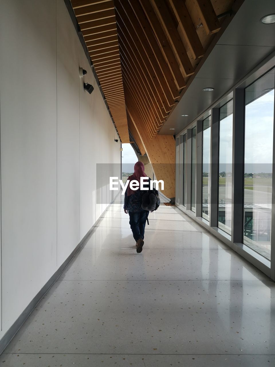 Lone traveler walking through a hallway