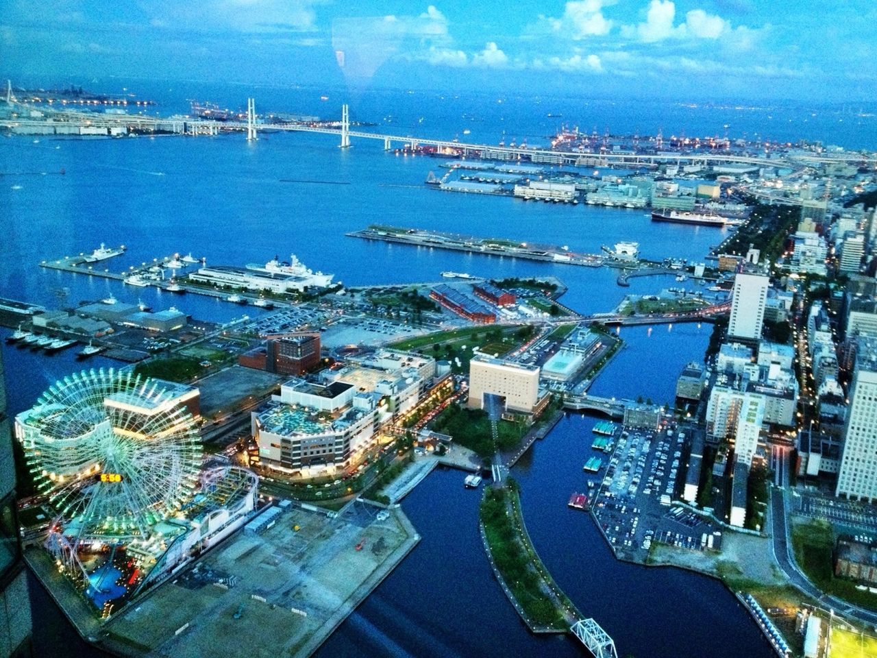 BOATS IN HARBOR WITH CITYSCAPE IN BACKGROUND