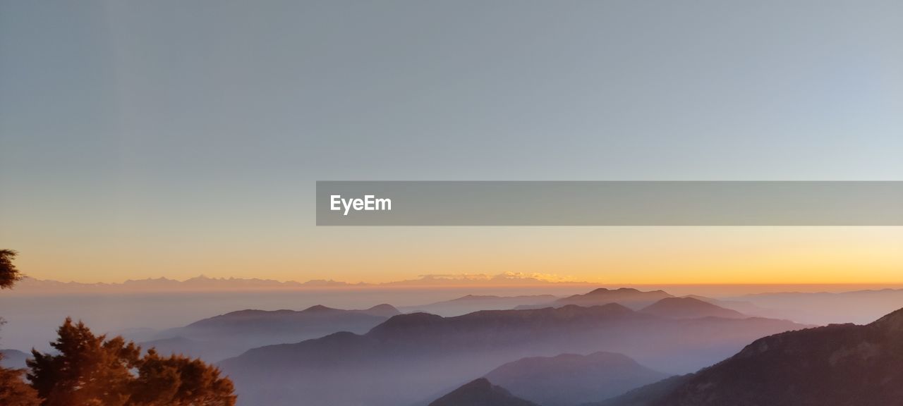 Scenic view of mountains against sky during sunset