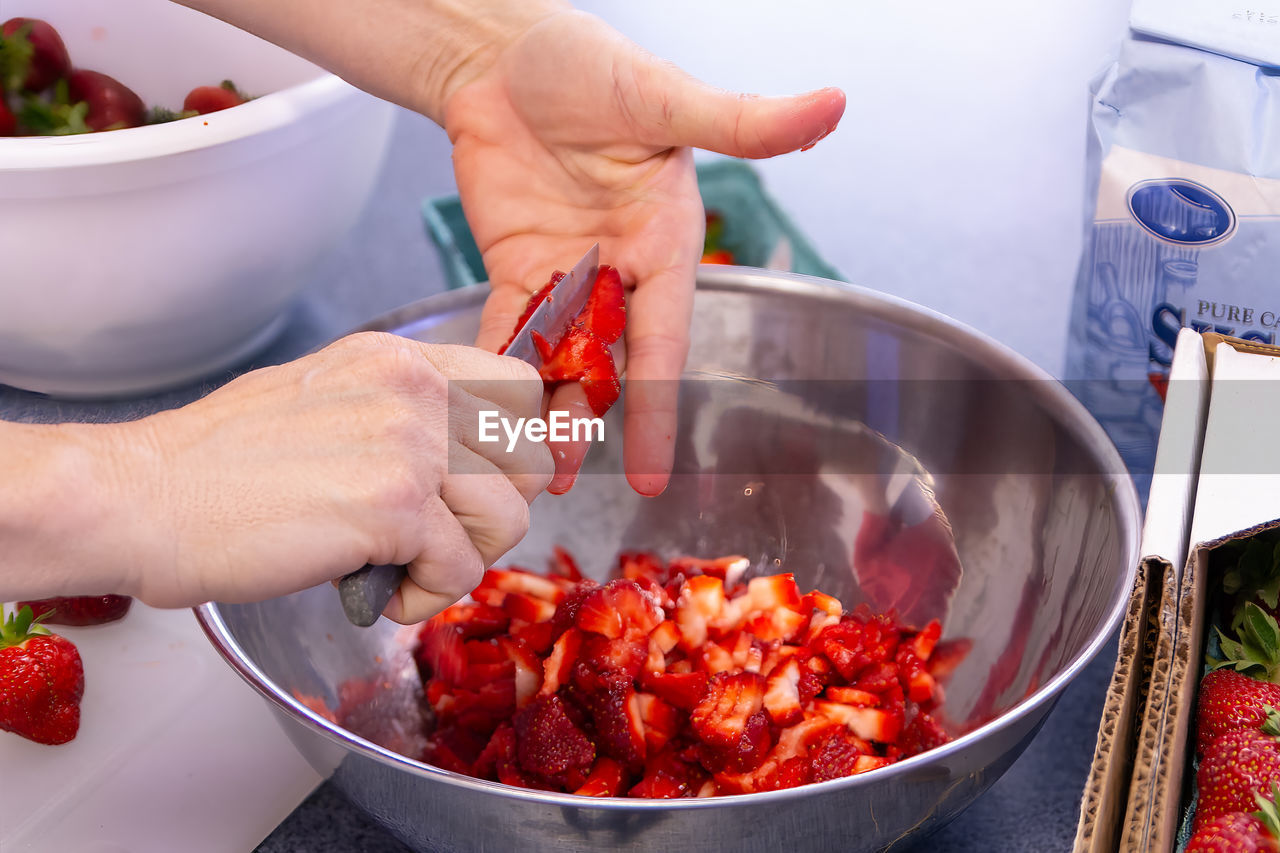 cropped hand of woman preparing food