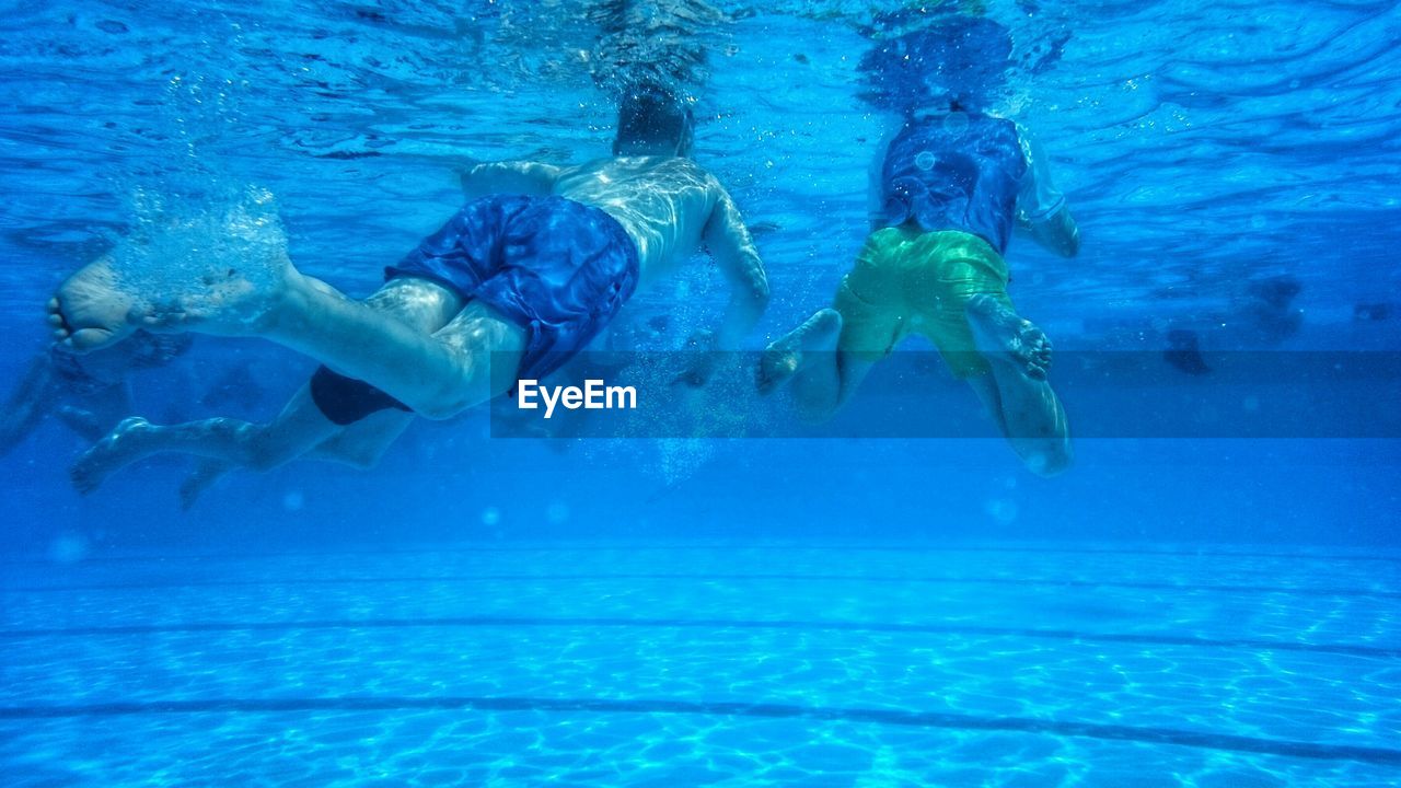 Two boys swimming in swimming pool