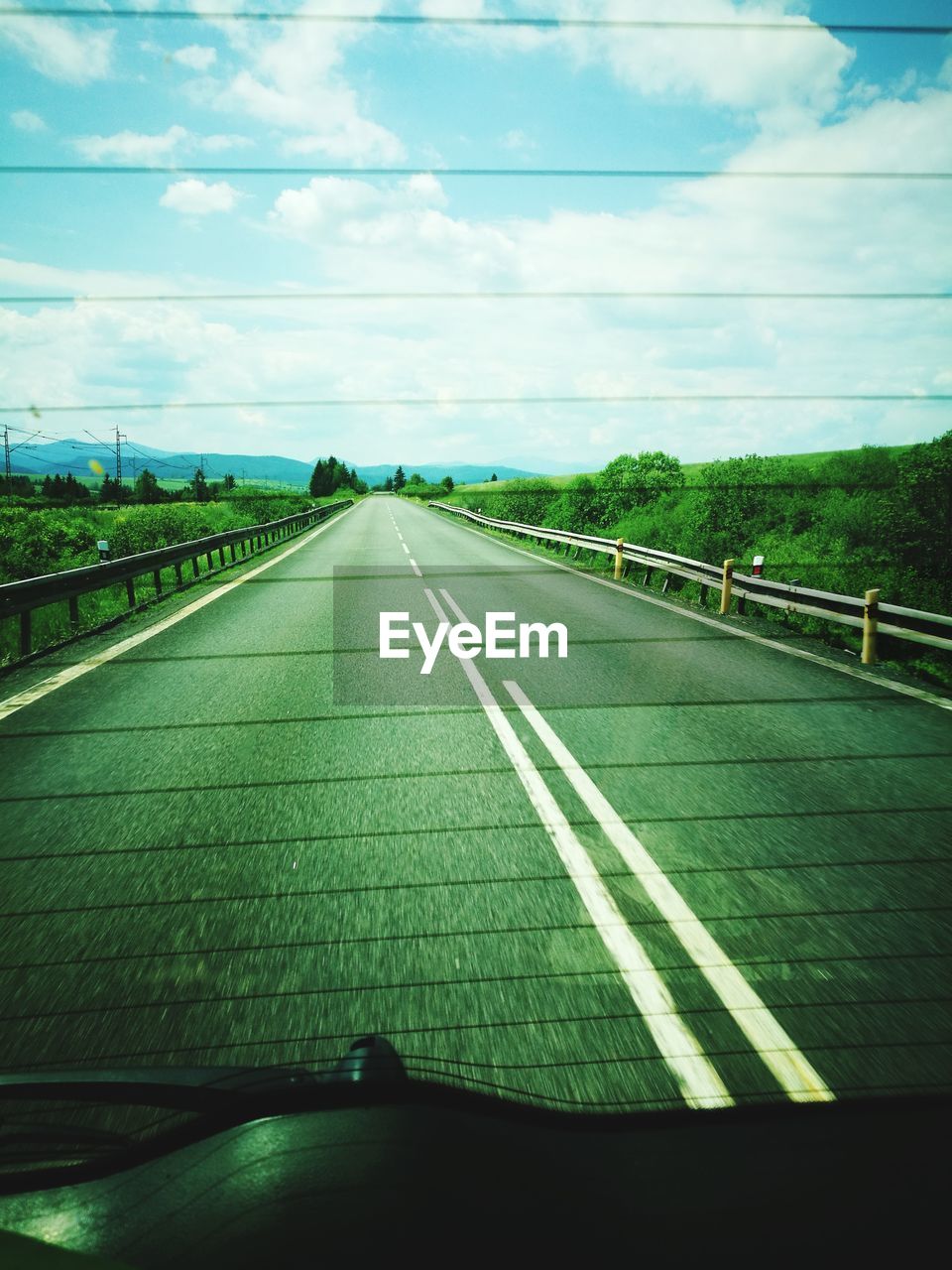 EMPTY ROAD ALONG LANDSCAPE AND AGAINST SKY