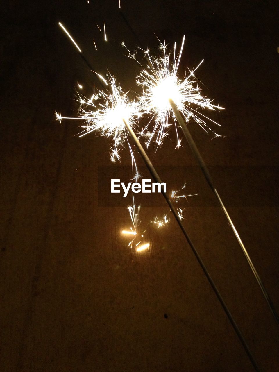 Close-up of lit sparkler at night