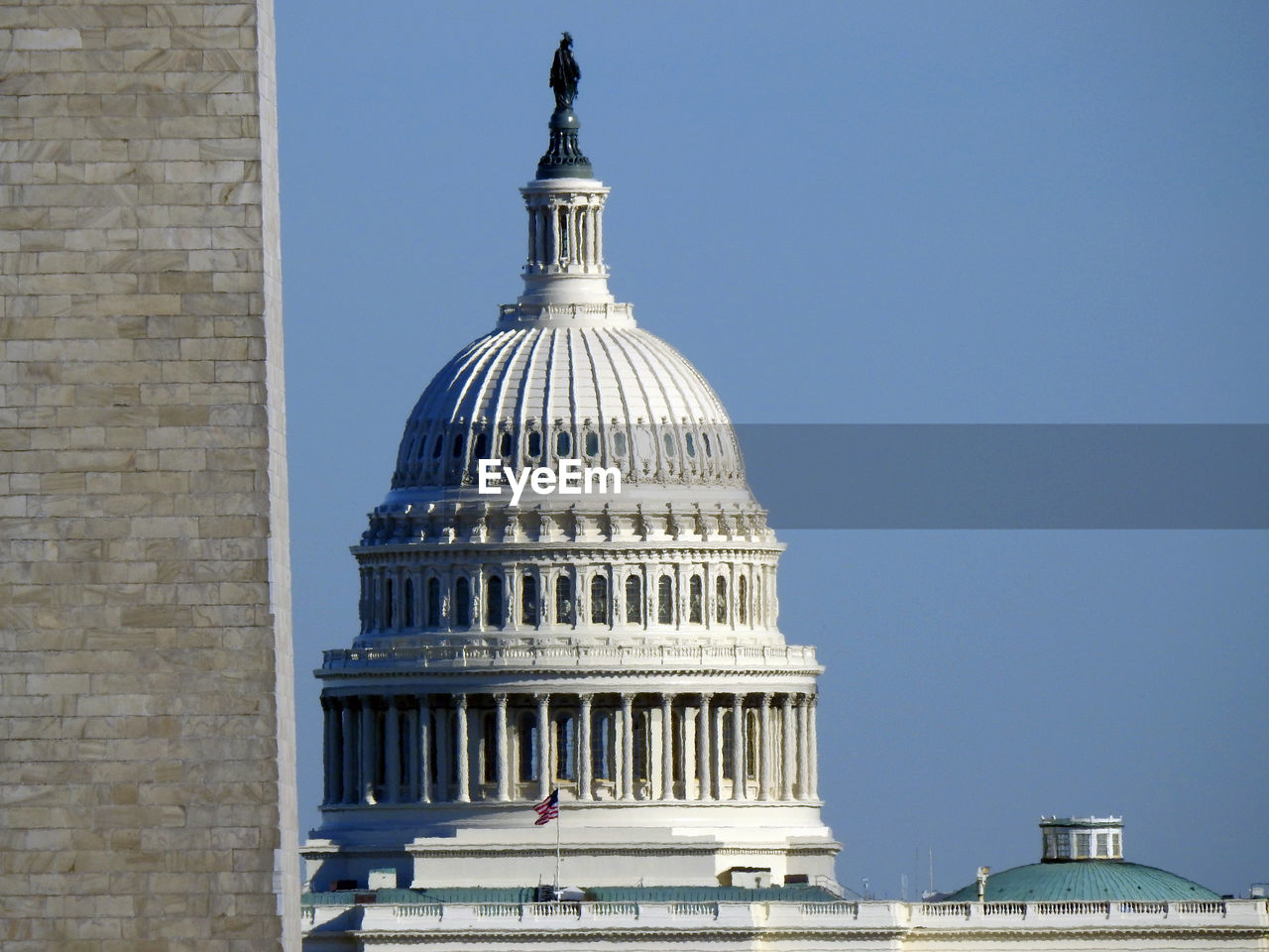  zoom view of the us capital rotunda with the washington monument on the side 