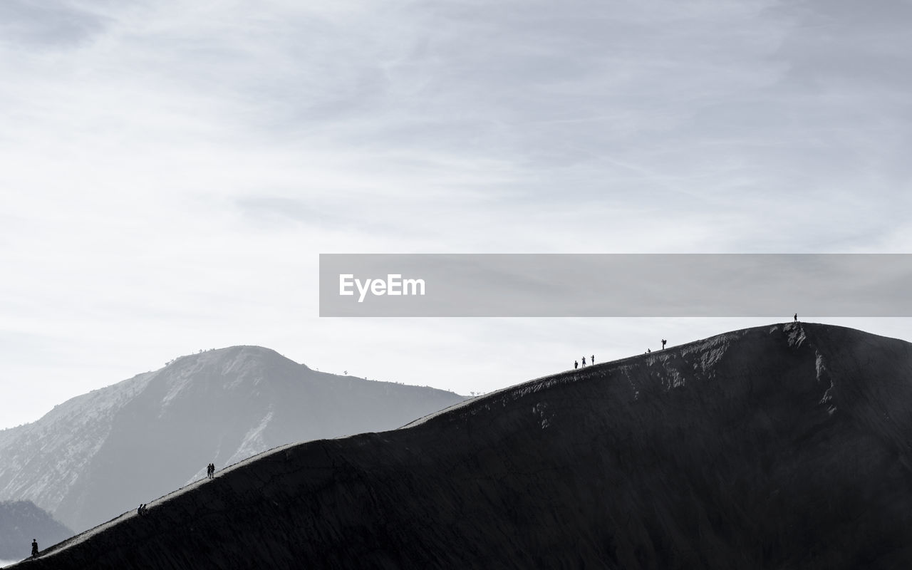 Low angle view of snowcapped mountains against sky