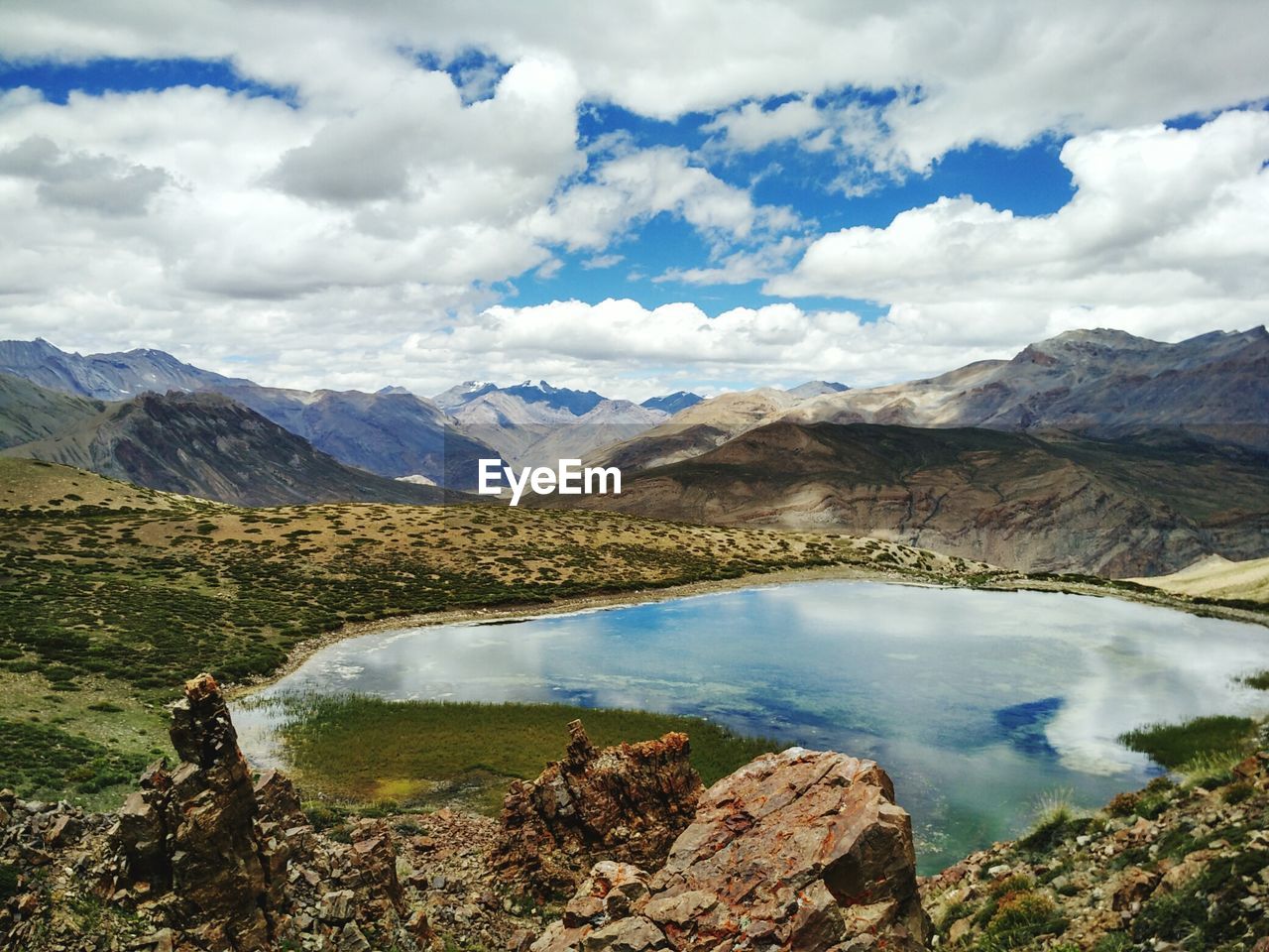 Scenic view of lake and mountains against sky