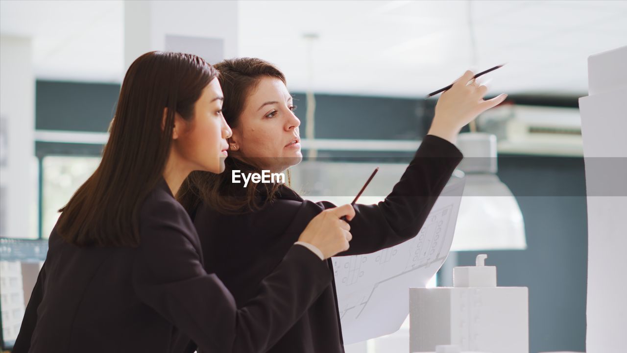 side view of young woman using mobile phone