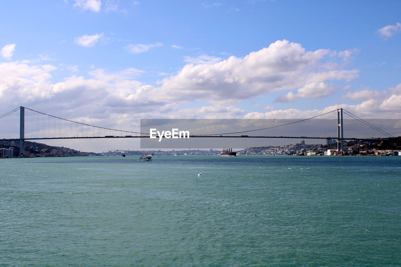 bridge, water, architecture, built structure, transportation, suspension bridge, sky, travel destinations, sea, travel, tourism, city, nature, engineering, cloud, scenics - nature, bay, bay of water, beauty in nature, cityscape, landscape, building exterior, tranquility, tranquil scene, copy space, nautical vessel, blue, urban skyline, land, outdoors, mode of transportation, environment, holiday, day, beach, horizon, cable-stayed bridge, dramatic sky, building, waterfront, idyllic, long, coastline, trip, city life, vacation, business finance and industry, sunlight, summer, panoramic, atmospheric mood, water's edge, shore, road, vehicle, street, rippled, highway, coast, industry, sunny, tall ship