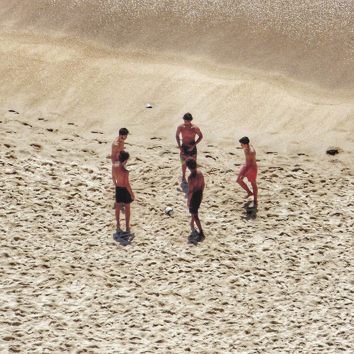 REAR VIEW OF FRIENDS WALKING ON BEACH