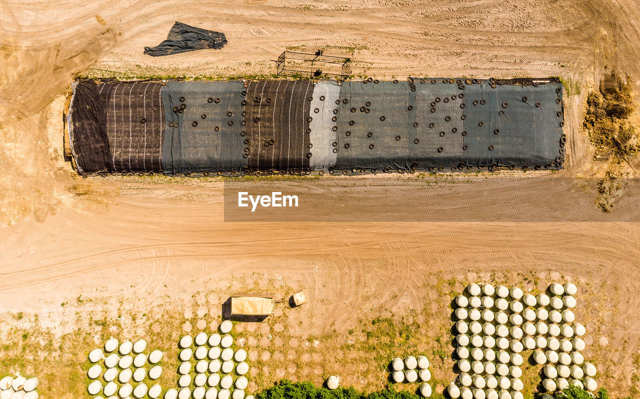 Aerial view of a farm camp, diagonal view of a large silage heap