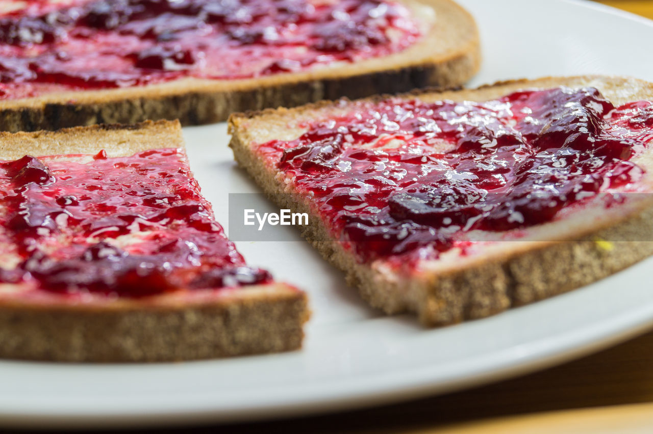 Close-up of breads with strawberry jam in plate