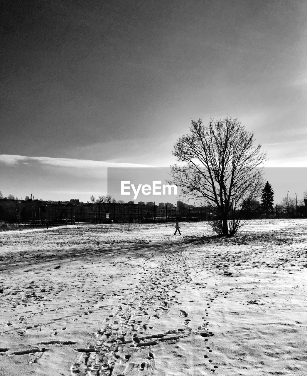 Scenic view of snow covered field against sky