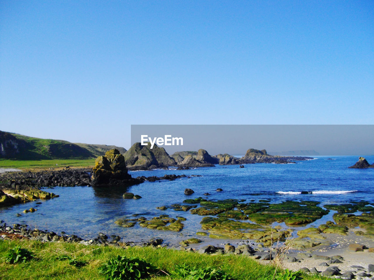 Scenic view of sea against clear blue sky