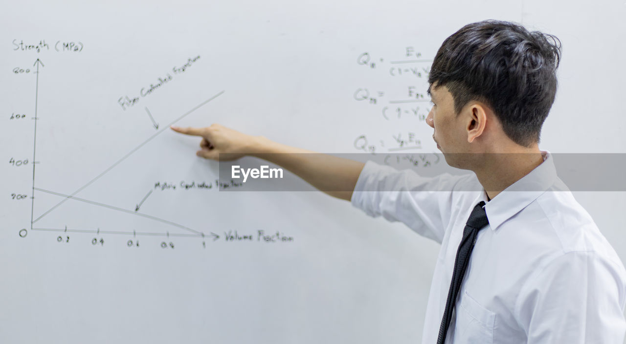 Teacher is teaching physics to students during the new school days after a long break