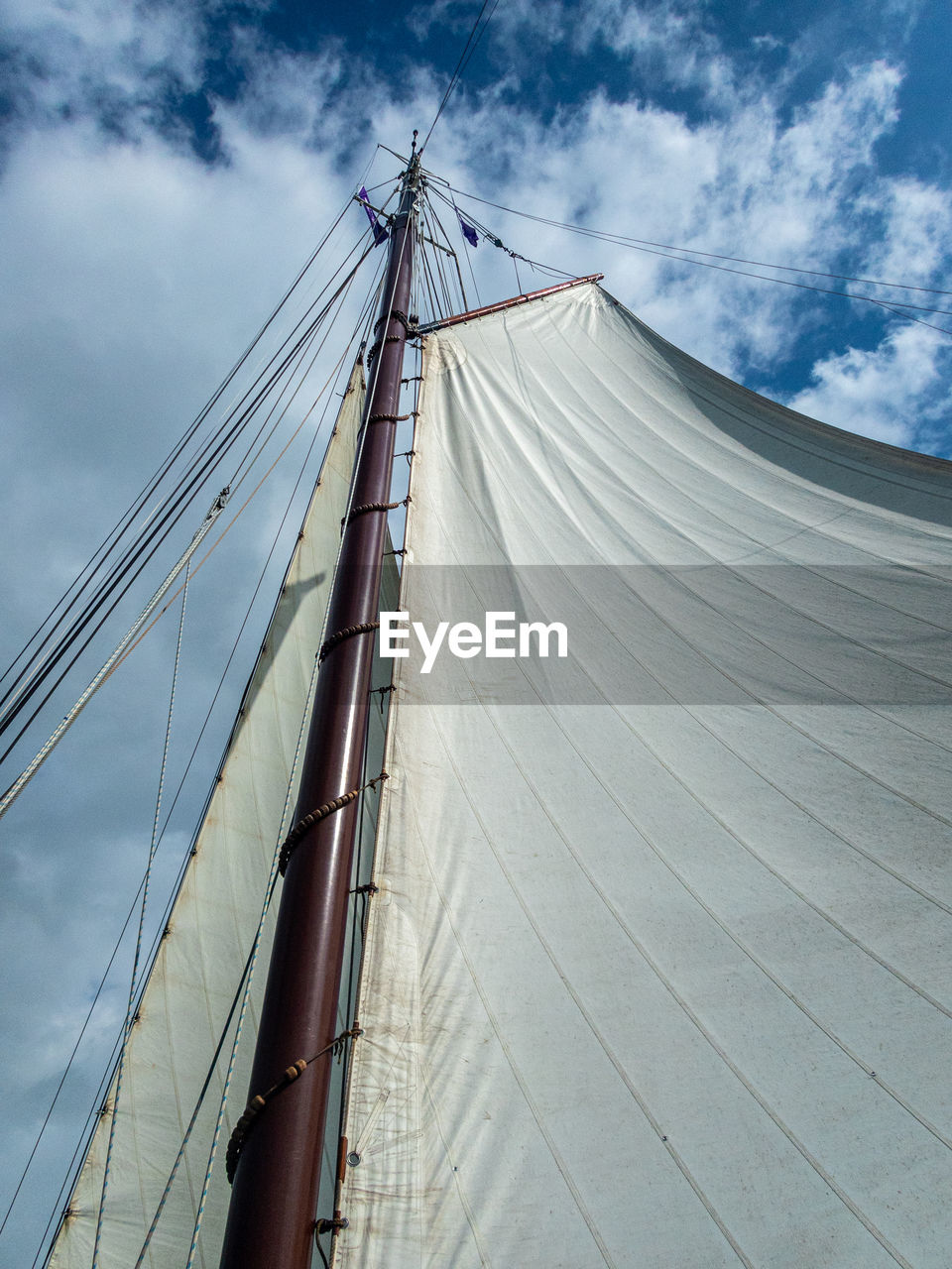 Low angle view of sailboat on bridge against sky