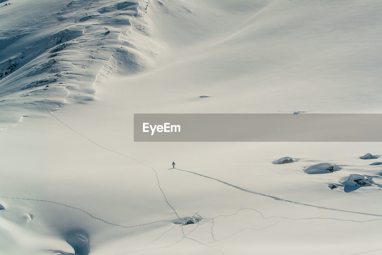 High angle view of person skiing on snow-covered field