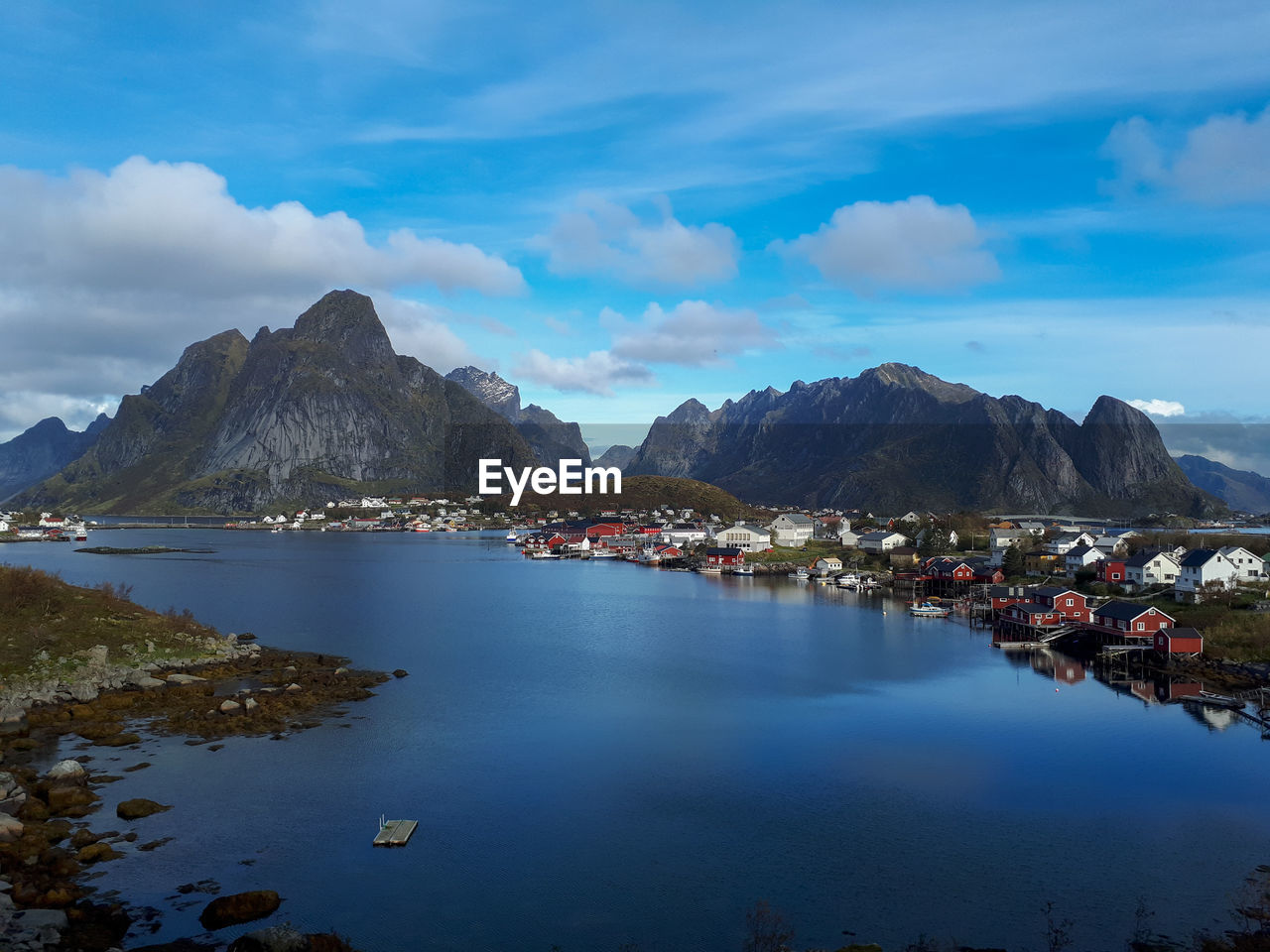 Scenic view of sea and mountains against sky