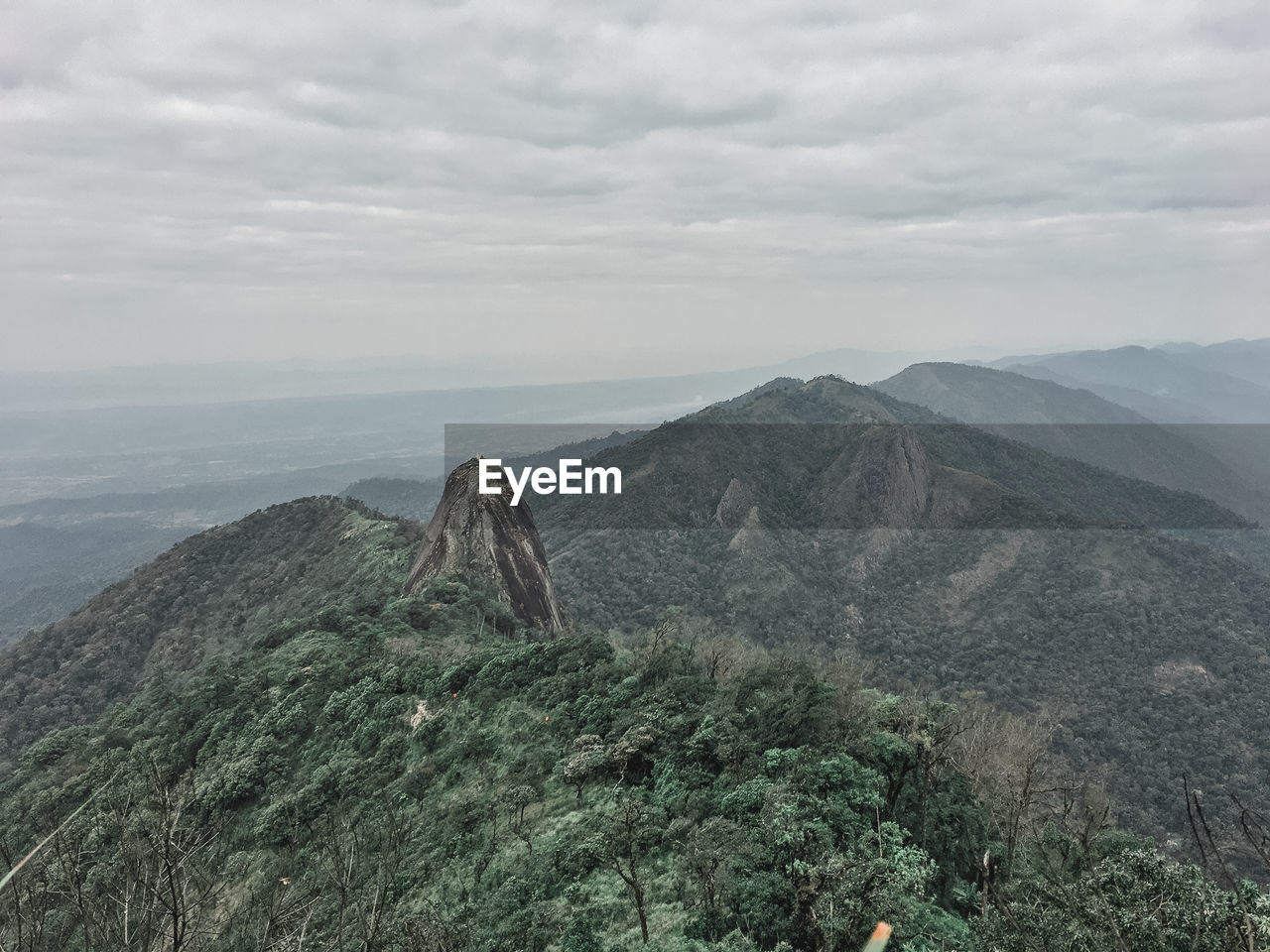 Scenic view of mountain against cloudy sky