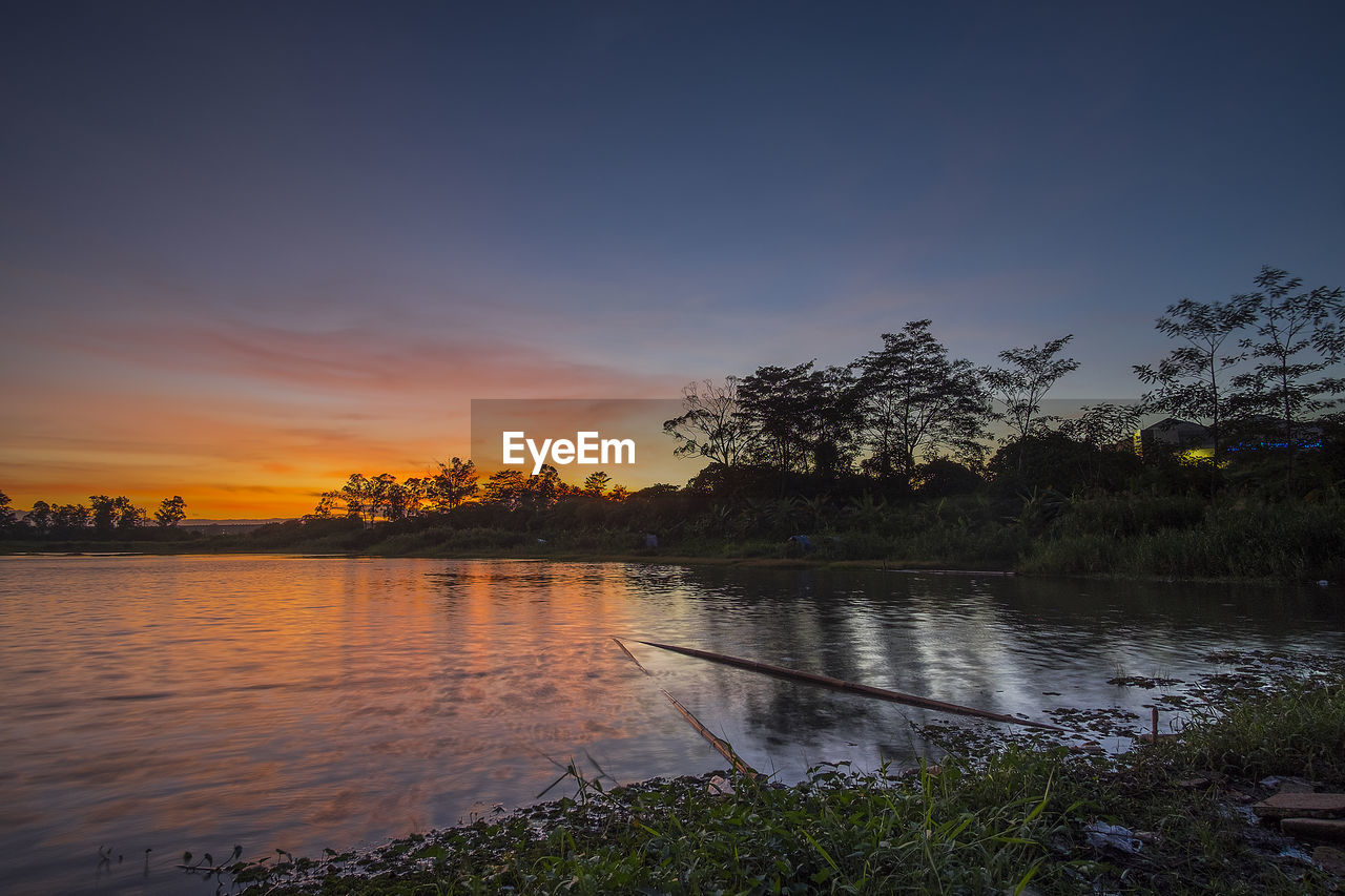 SCENIC VIEW OF LAKE AT SUNSET