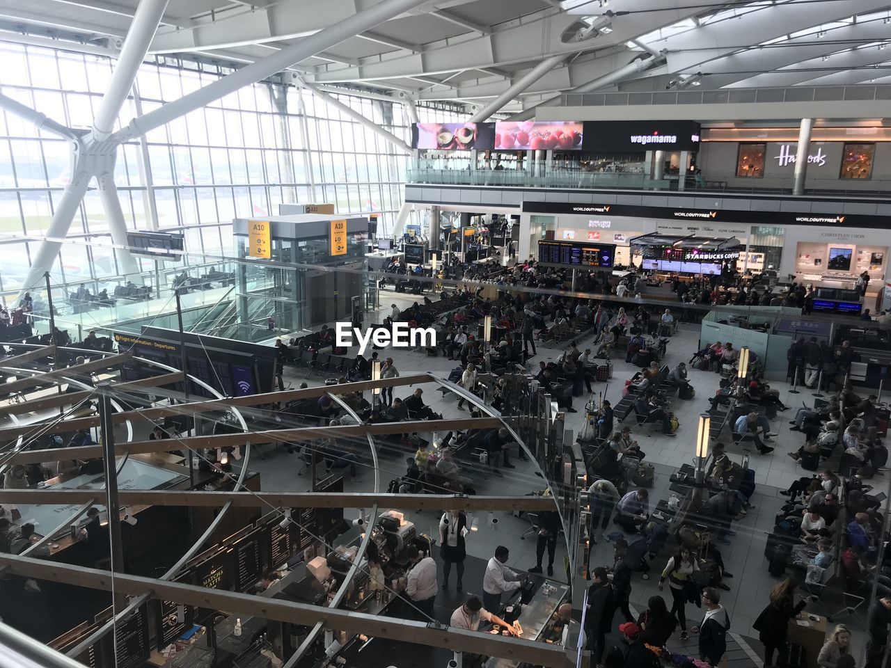 HIGH ANGLE VIEW OF PEOPLE ON AIRPORT