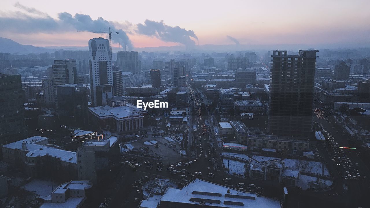 High angle view of buildings against sky during sunset